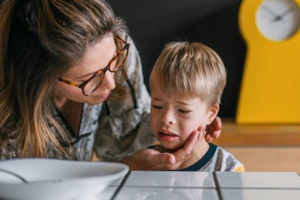 A woman and a child are at a table, creating a moment of connection and interaction between them